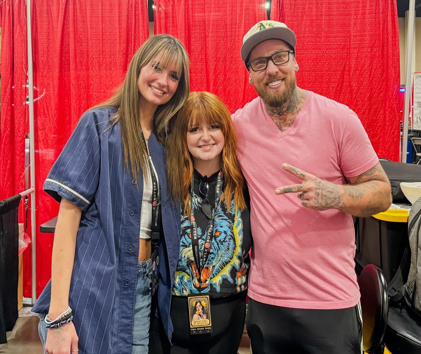 Three of the crew at Moxy Tattoo Studio, standing together in the shop.