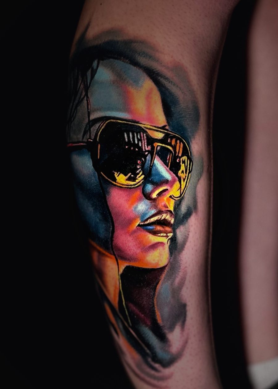 Color portrait tattoo of a face in aviator sunglasses.