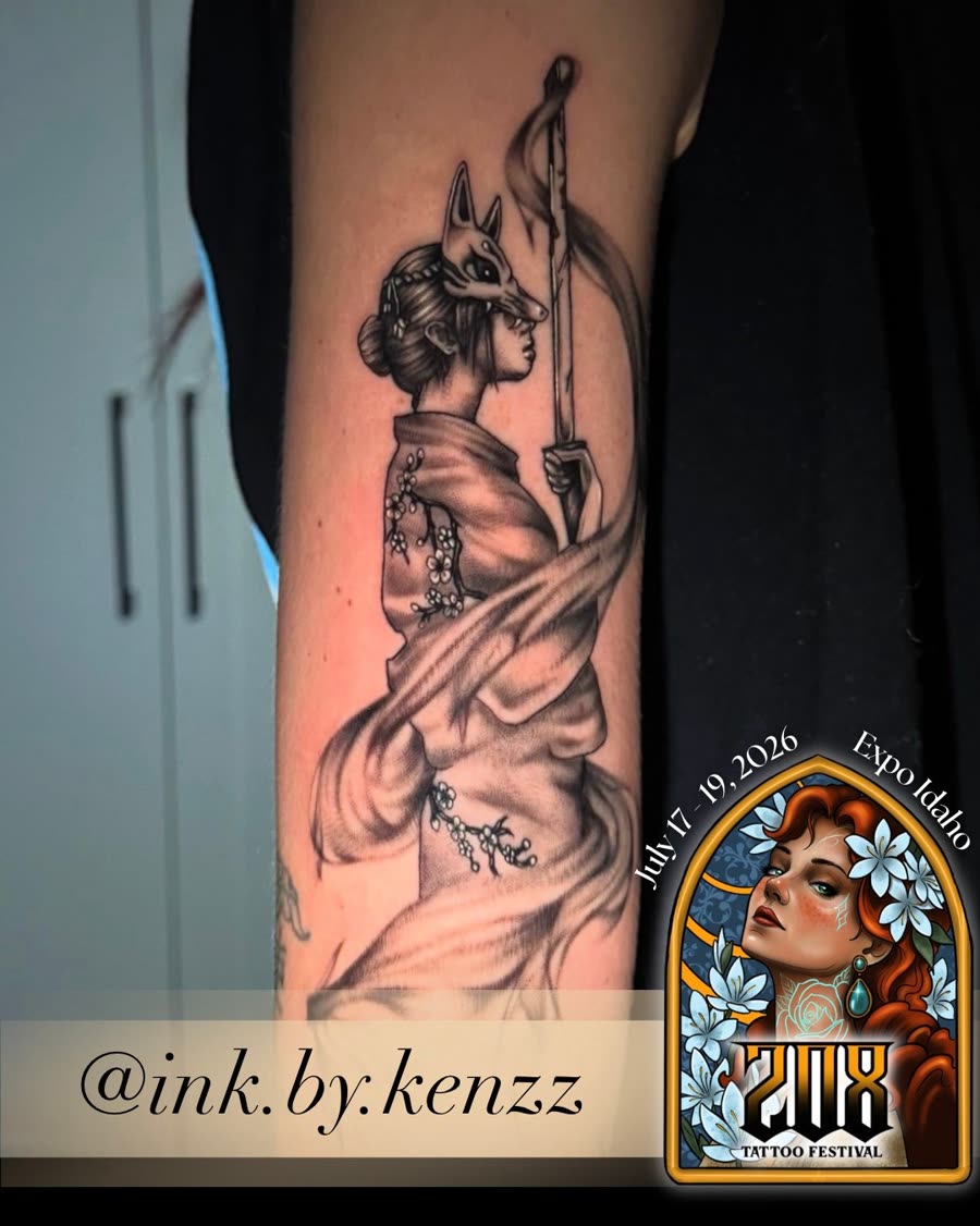 Black and grey robed figure with ornamental detail running down an arm.