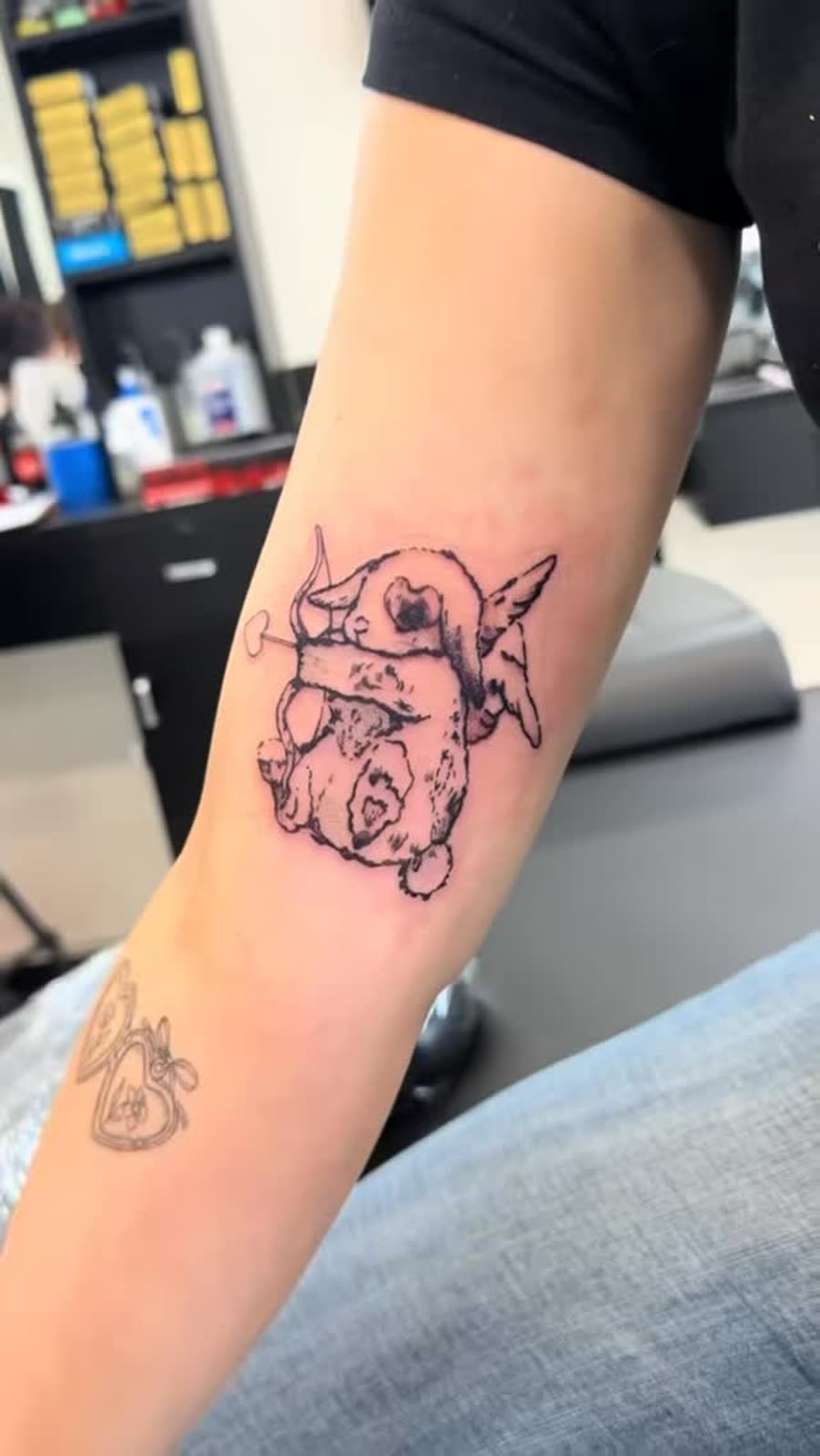 Small fine line outline piece tattooed on a forearm.