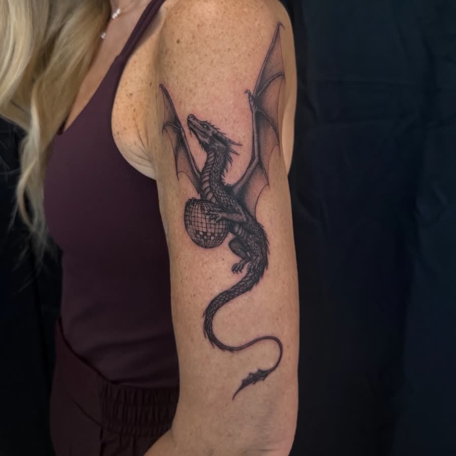 Black and grey snake coiling down an upper arm.