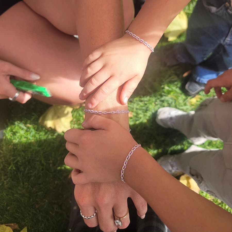 Matching permanent chain bracelets welded on at a pop-up.