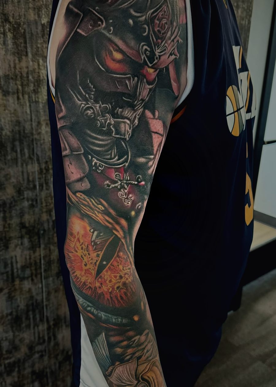 Color sleeve of a samurai in oni armor with fire and a koi down the forearm.