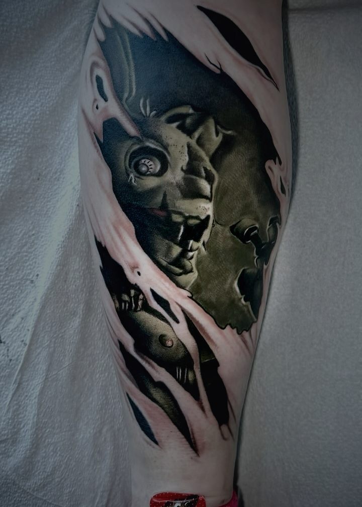 Torn skin effect tattoo on a calf showing detail underneath.
